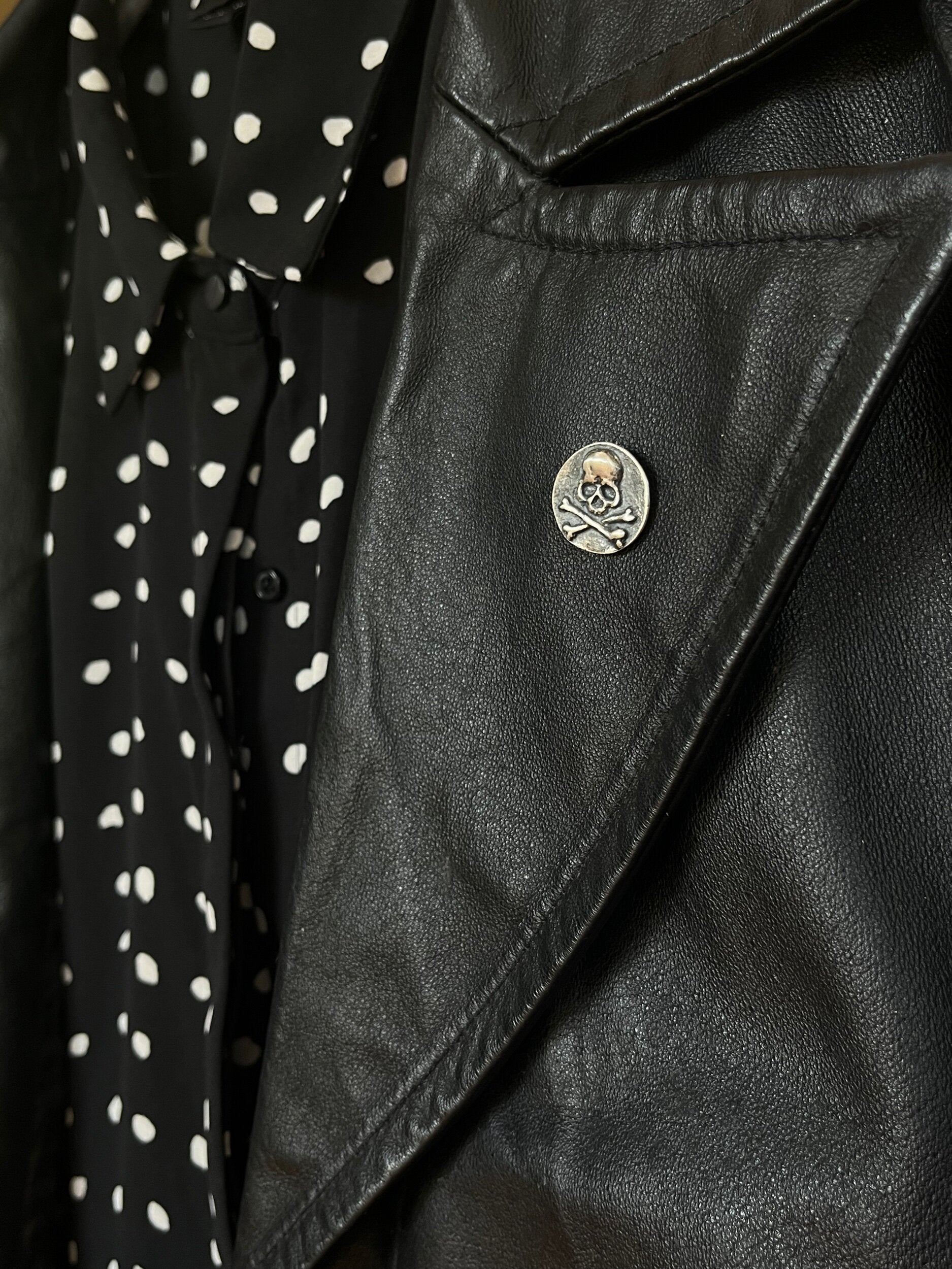 Skullbones Coin Lapel Pin These solid sterling silver SkullBones Coin Lapel Pin can also be worn as a Tie Tack. This Skullbones Coin is wax carved by hand and cast using the ancient process of Lost Wax to cast them in sterling silver. I then made a mold,