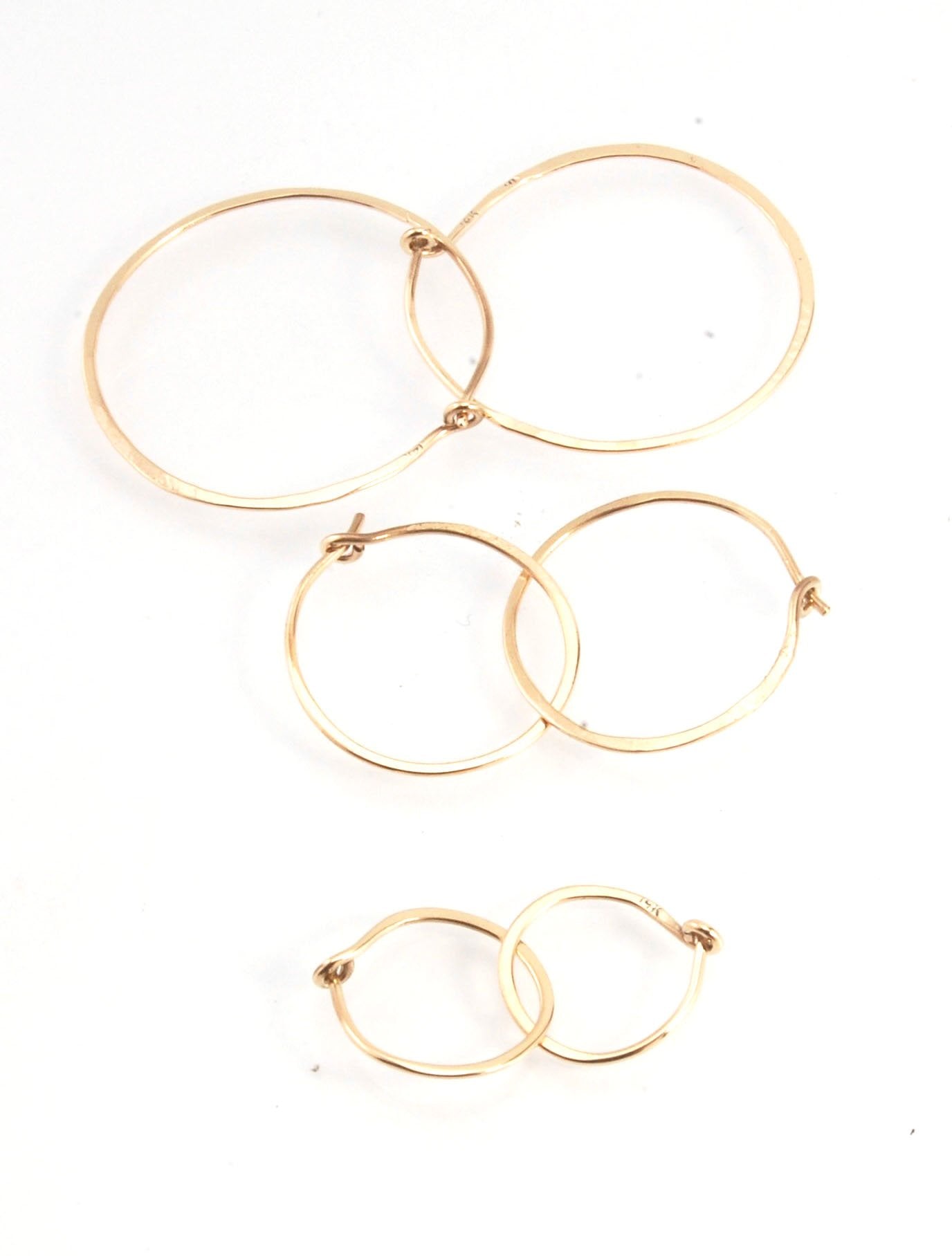 Hammered 14k Hoops - Small, Medium and Large These are exactly the same as my hammered sterling hoops, but they are made of solid 14k gold! They are super lightweight, classic wire hammered hoops you can sleep and live in. These delicate hoops are forged
