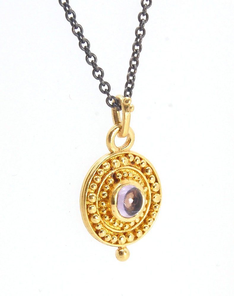 Amethyst 18k Gold Granulation Medallion This lovely light amethyst cabochon is surrounded by the 18k gold bezel setting and 18k gold granulation with a notched granulated bail. This classically inspired medallion looks like it could have come from buried