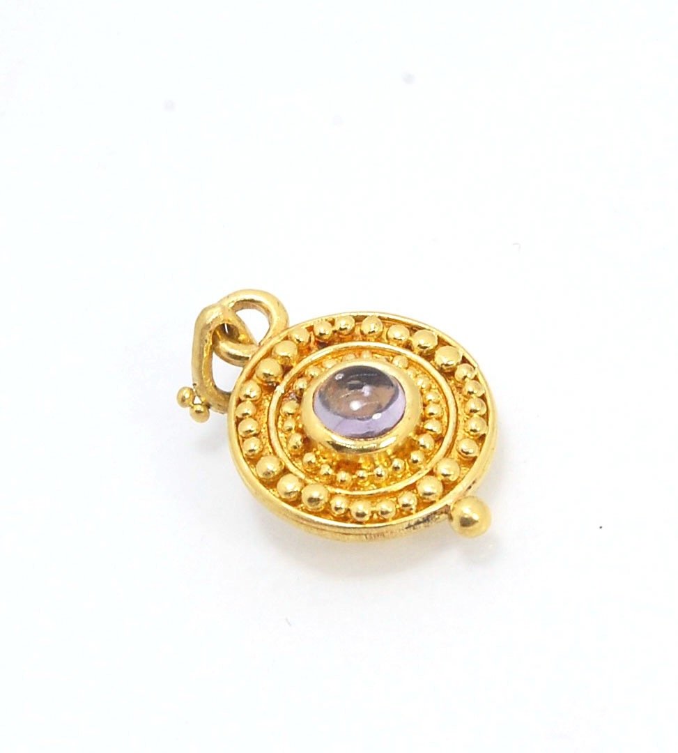 Amethyst 18k Gold Granulation Medallion This lovely light amethyst cabochon is surrounded by the 18k gold bezel setting and 18k gold granulation with a notched granulated bail. This classically inspired medallion looks like it could have come from buried