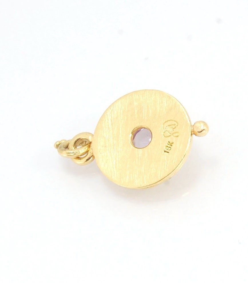 Amethyst 18k Gold Granulation Medallion This lovely light amethyst cabochon is surrounded by the 18k gold bezel setting and 18k gold granulation with a notched granulated bail. This classically inspired medallion looks like it could have come from buried