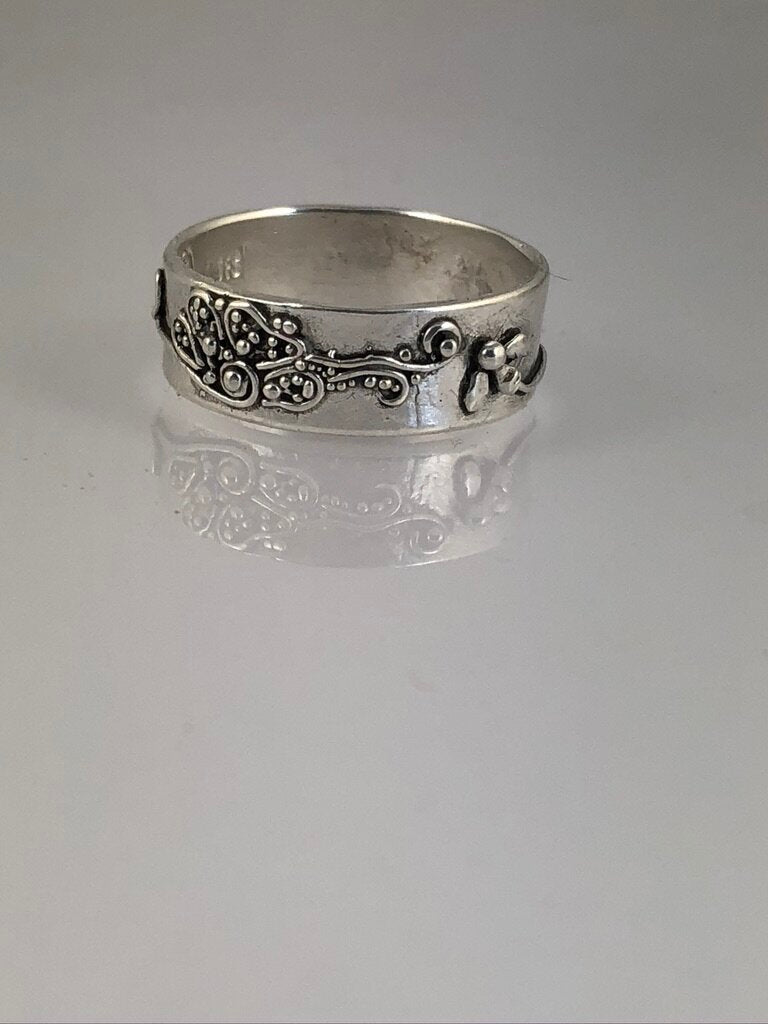 Pollinator Ring This Pollinator Band has a Bee and flower in tiny granulation. This band is a cast from a mold taken of a ring I granulated in fine silver. Granulation is an ancient fusing process that can only be done in certain highly pure metals that w