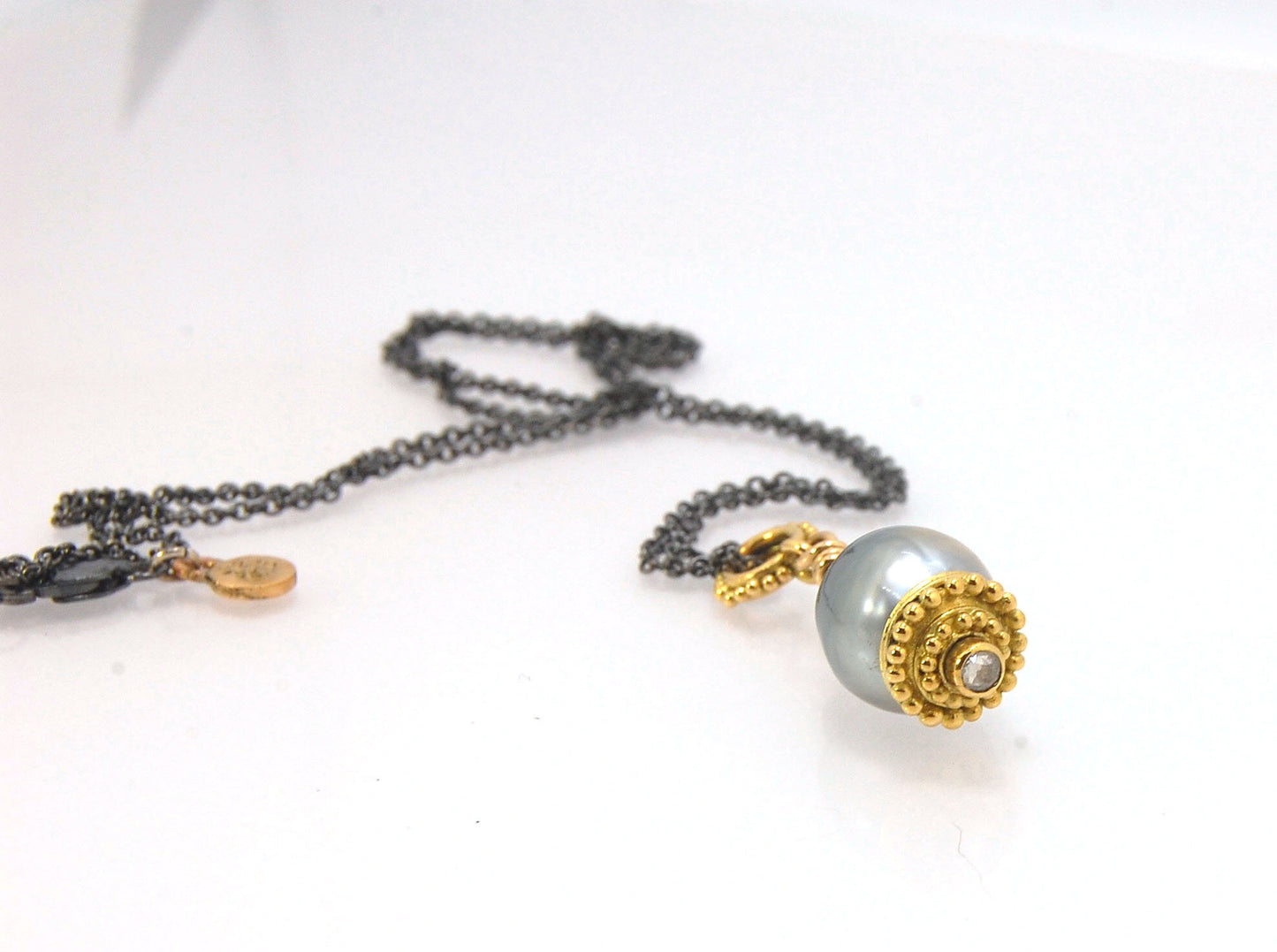 Baroque Grey Pearl with 18k gold Granulation and a Rosecut Diamond Ok this one is a stunner. 18k gold Granulated Dome with a 2.5 mm Rosecut Diamond and Granulated Bail pictured on an 18” peacock black oxidized Sterling Silver chain. Granulation is an anci