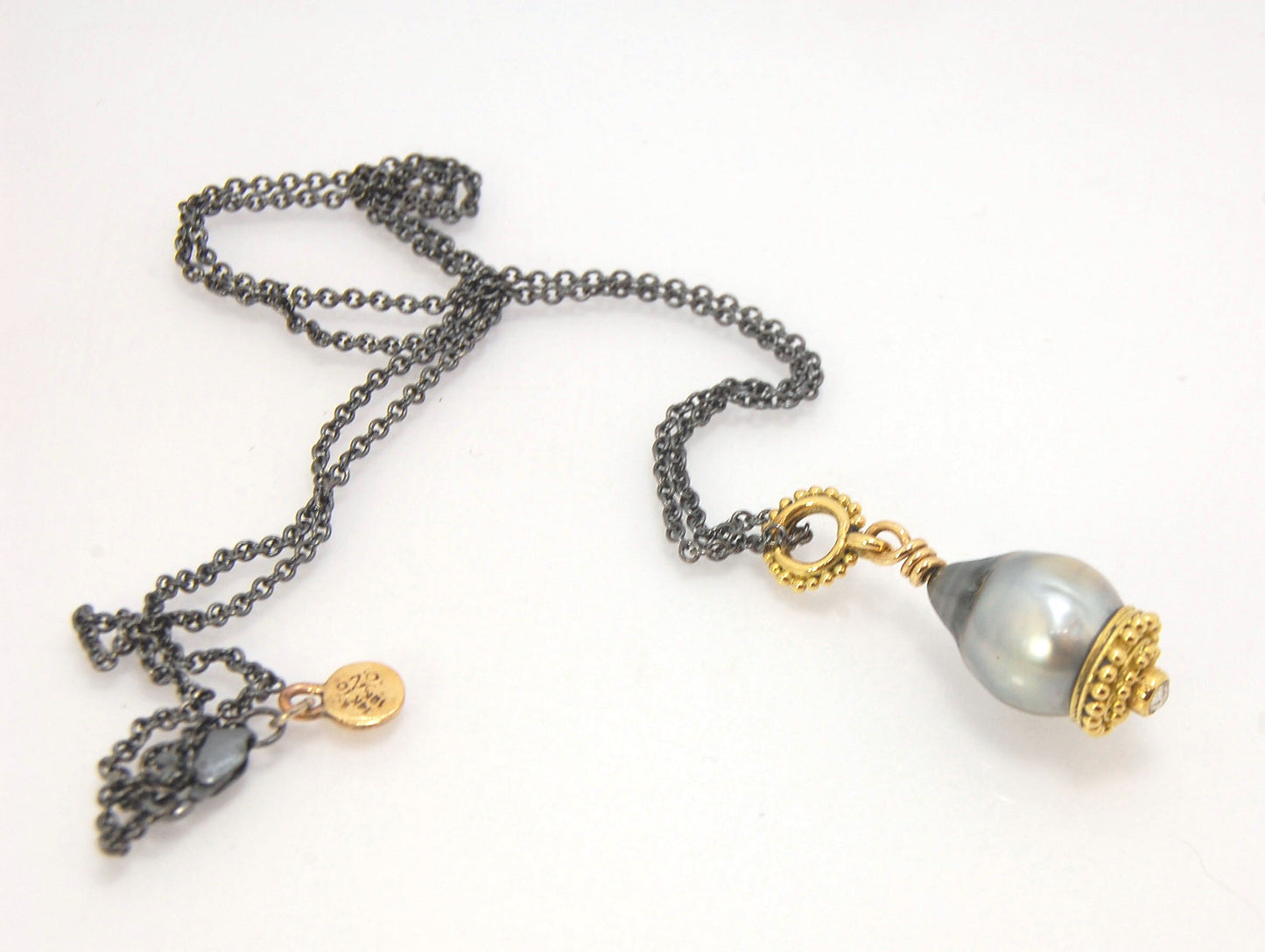 Baroque Grey Pearl with 18k gold Granulation and a Rosecut Diamond Ok this one is a stunner. 18k gold Granulated Dome with a 2.5 mm Rosecut Diamond and Granulated Bail pictured on an 18” peacock black oxidized Sterling Silver chain. Granulation is an anci
