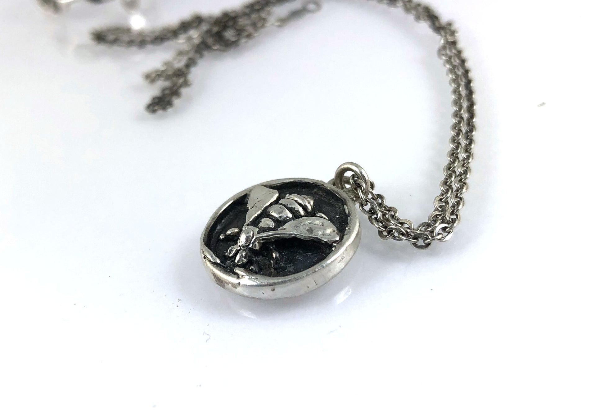 Bee Coin Necklace Carved in wax and cast using the lost-wax process in Sterling Silver, this bee coin was SO MUCH FUN to carve! I have made a mold and will be casting them to order. I inject the mold with wax and use that wax to cast using a lost-wax proc