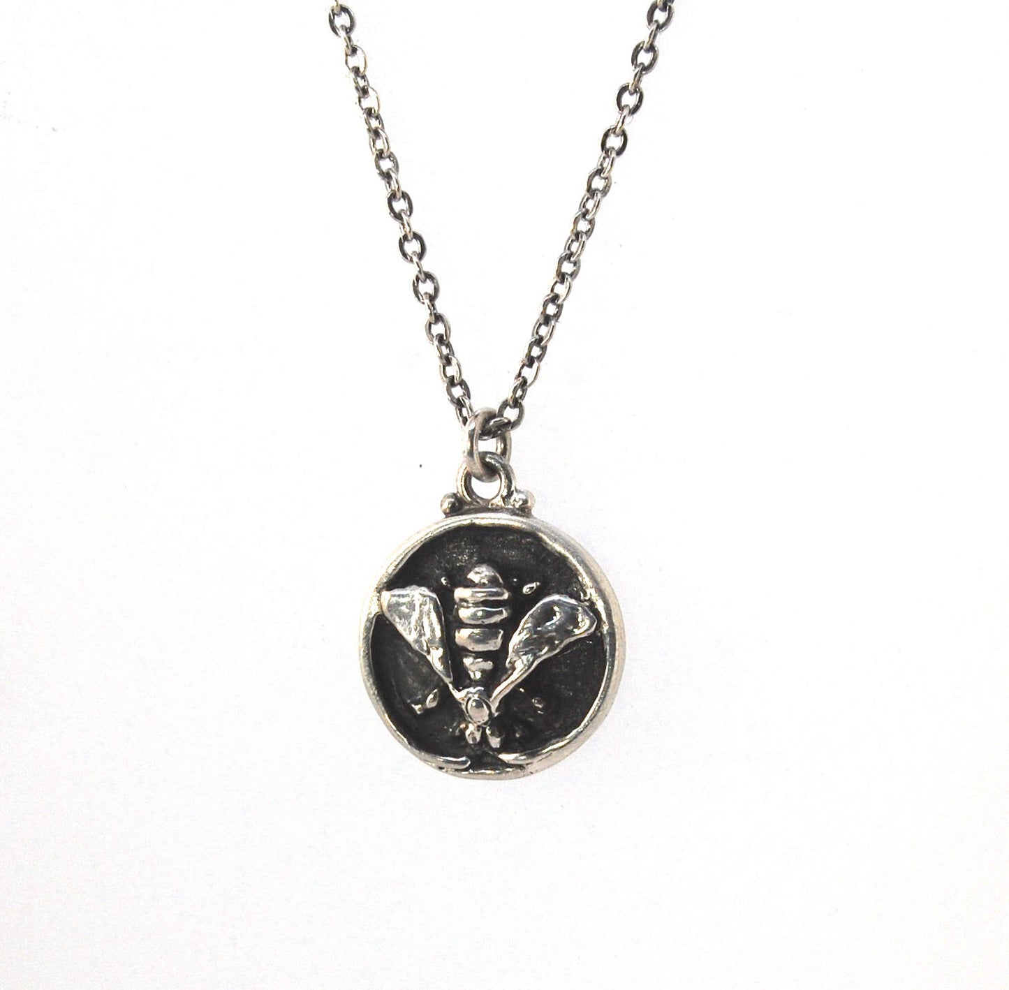 Bee Coin Necklace Carved in wax and cast using the lost-wax process in Sterling Silver, this bee coin was SO MUCH FUN to carve! I have made a mold and will be casting them to order. I inject the mold with wax and use that wax to cast using a lost-wax proc