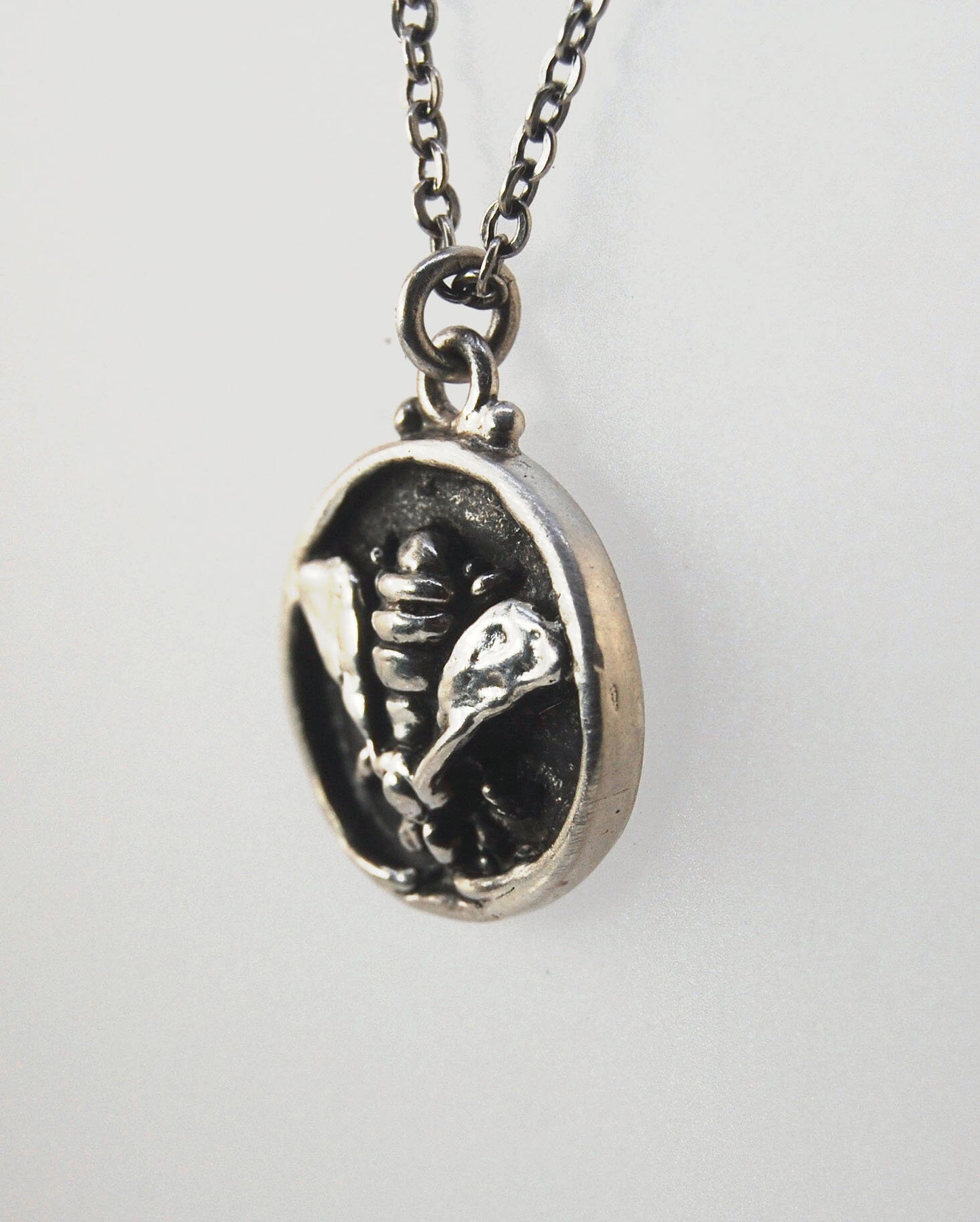 Bee Coin Necklace Carved in wax and cast using the lost-wax process in Sterling Silver, this bee coin was SO MUCH FUN to carve! I have made a mold and will be casting them to order. I inject the mold with wax and use that wax to cast using a lost-wax proc