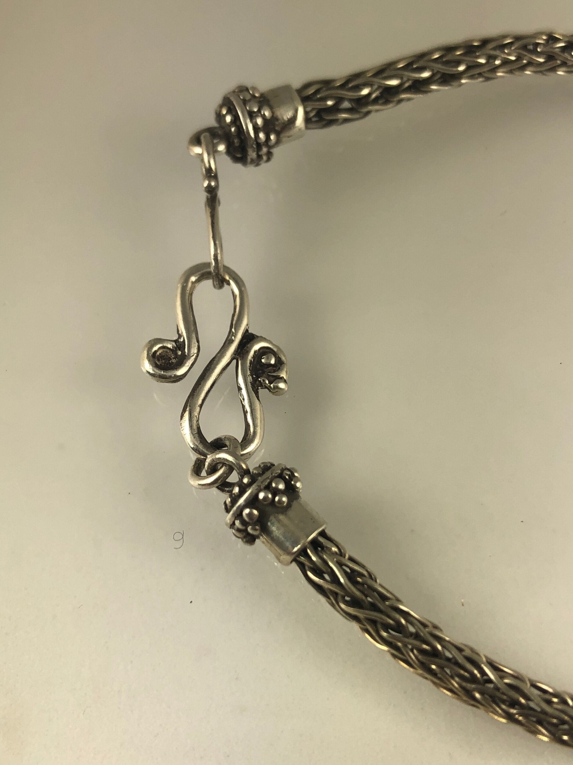 Viking Knit Woven Silver Bracelet with granulated caps and S clasp- cast,fine silver,fine silver granulation,Sterling Silver,woven chain These great woven bracelets are handwoven from fine silver with a cast granulated cap and S clasp. The original cap an