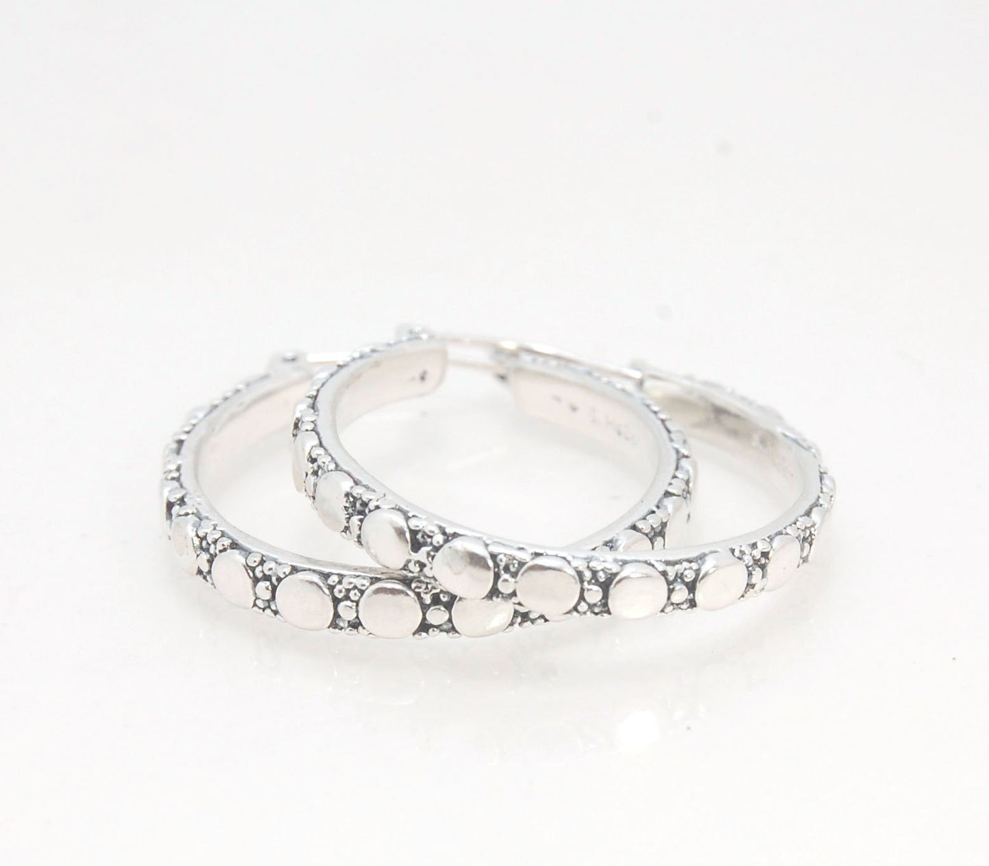 Disc Hoops - Sterling in 3 sizes These Hoops are made from a Disc pattern with heavy granules and ingot slices and have a hoop catch with a satisfying snap and come in three sizes:Large - 4mm wide and 1.25” in diameterMedium - 4mm wide and .75” in diamete