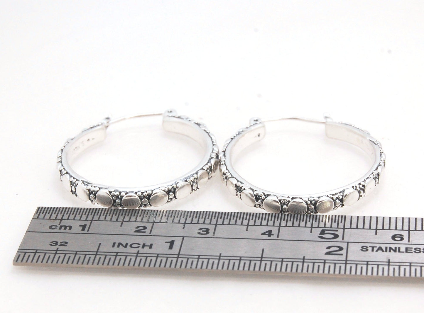 Disc Hoops - Sterling in 3 sizes These Hoops are made from a Disc pattern with heavy granules and ingot slices and have a hoop catch with a satisfying snap and come in three sizes:Large - 4mm wide and 1.25” in diameterMedium - 4mm wide and .75” in diamete
