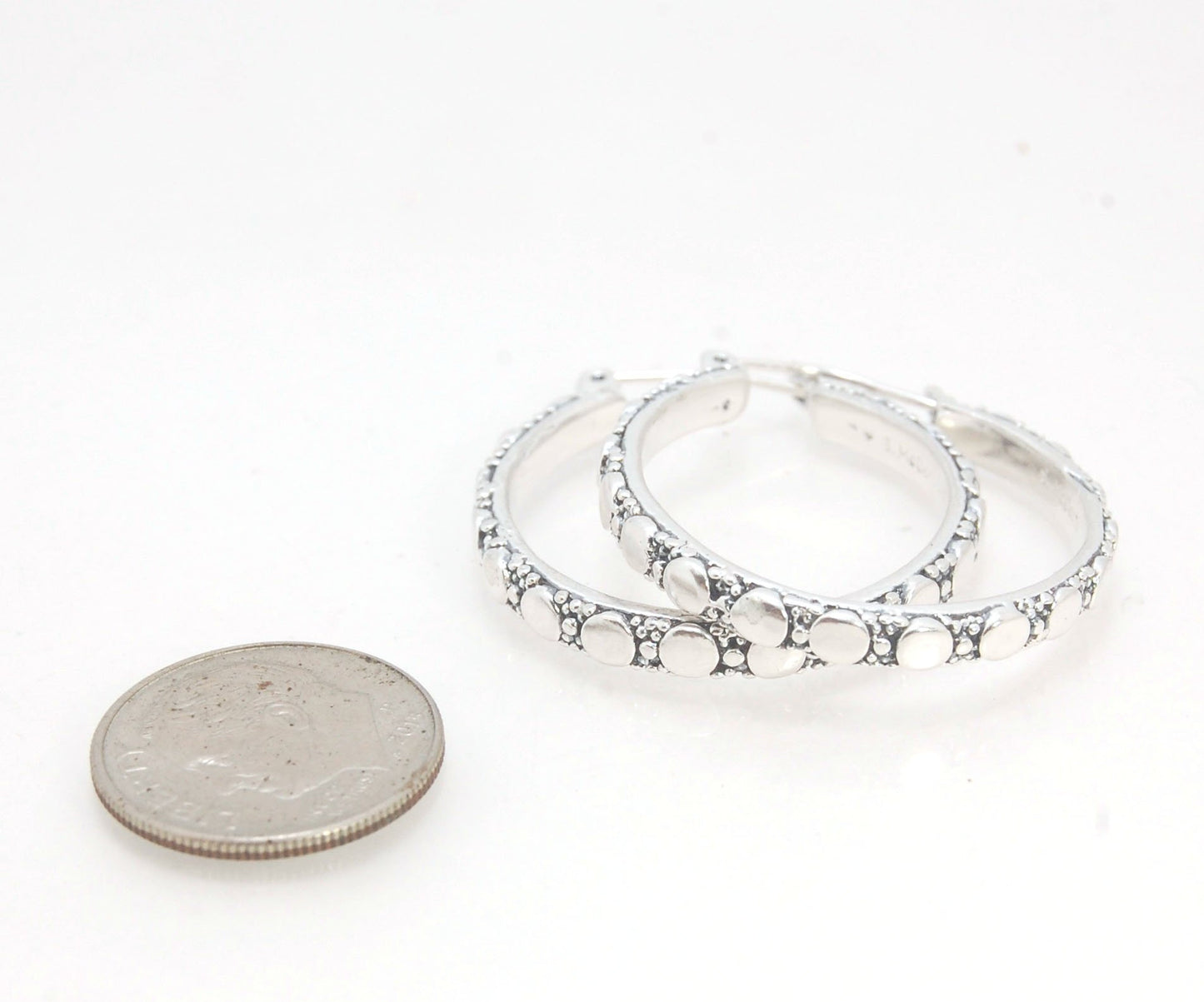 Disc Hoops - Sterling in 3 sizes These Hoops are made from a Disc pattern with heavy granules and ingot slices and have a hoop catch with a satisfying snap and come in three sizes:Large - 4mm wide and 1.25” in diameterMedium - 4mm wide and .75” in diamete