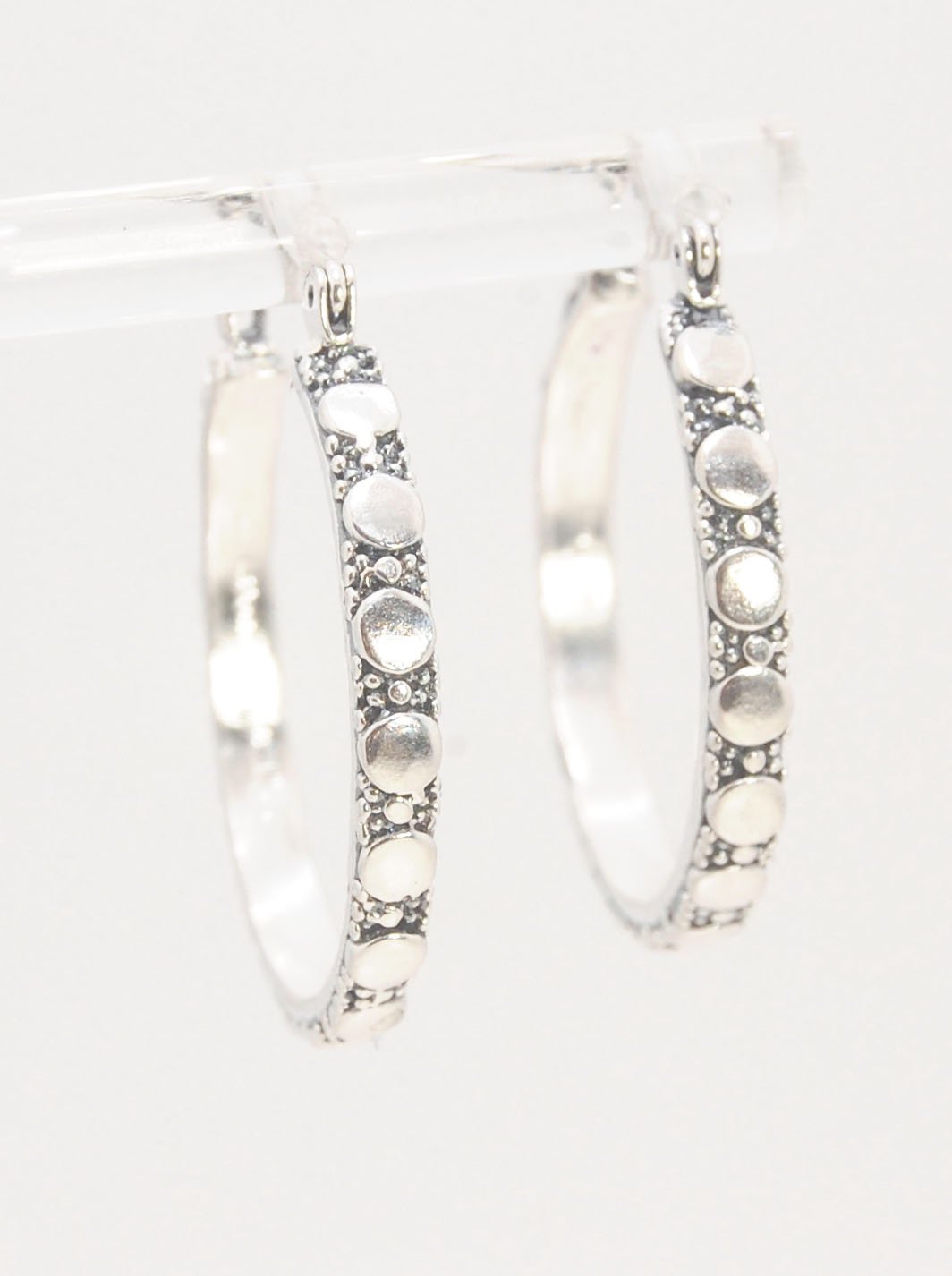 Disc Hoops - Sterling in 3 sizes These Hoops are made from a Disc pattern with heavy granules and ingot slices and have a hoop catch with a satisfying snap and come in three sizes:Large - 4mm wide and 1.25” in diameterMedium - 4mm wide and .75” in diamete