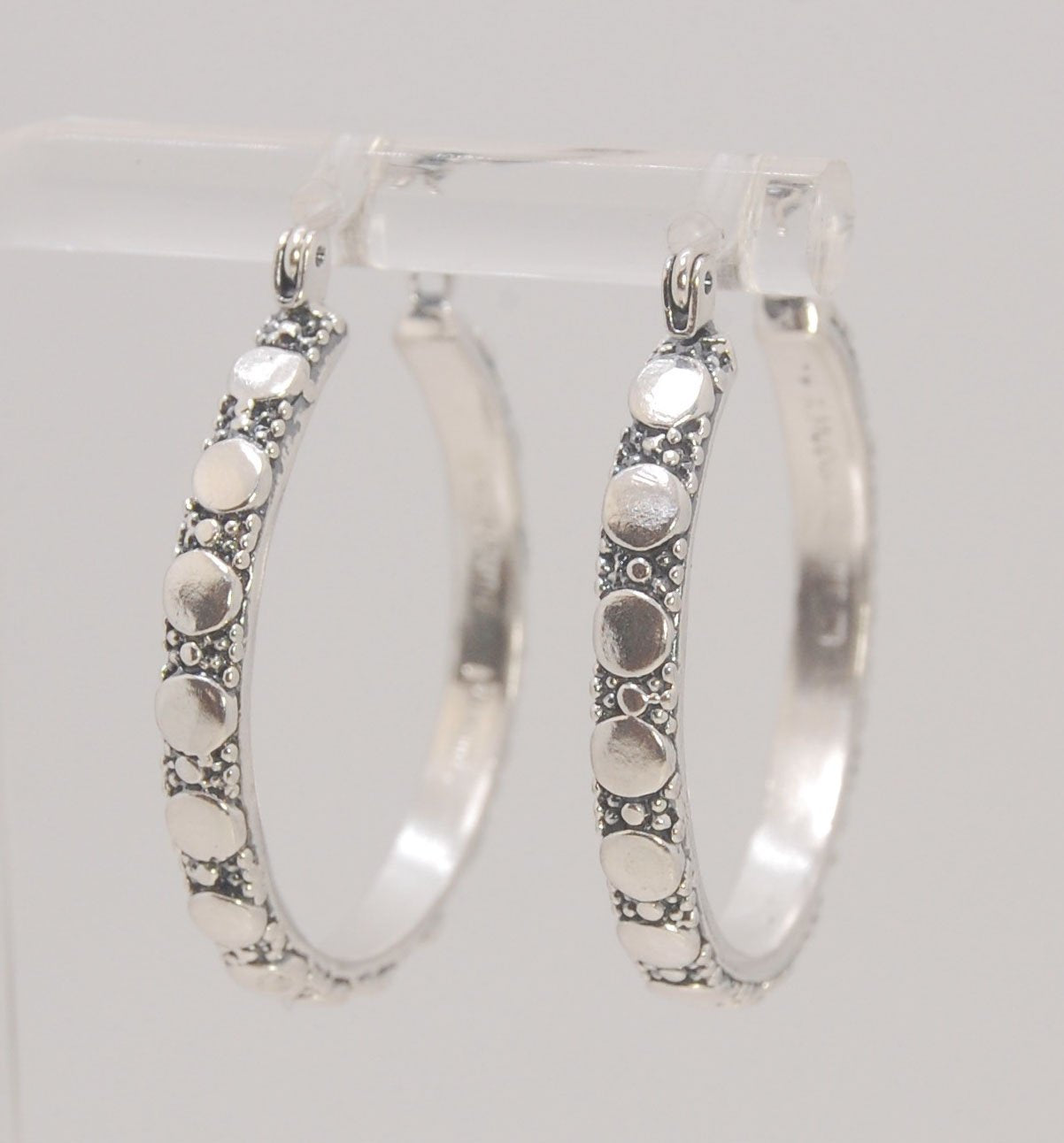 Disc Hoops - Sterling in 3 sizes These Hoops are made from a Disc pattern with heavy granules and ingot slices and have a hoop catch with a satisfying snap and come in three sizes:Large - 4mm wide and 1.25” in diameterMedium - 4mm wide and .75” in diamete