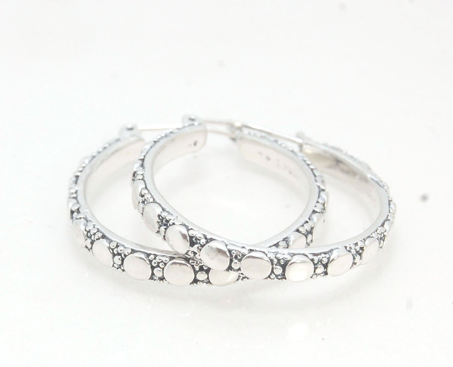 Disc Hoops - Sterling in 3 sizes These Hoops are made from a Disc pattern with heavy granules and ingot slices and have a hoop catch with a satisfying snap and come in three sizes:Large - 4mm wide and 1.25” in diameterMedium - 4mm wide and .75” in diamete