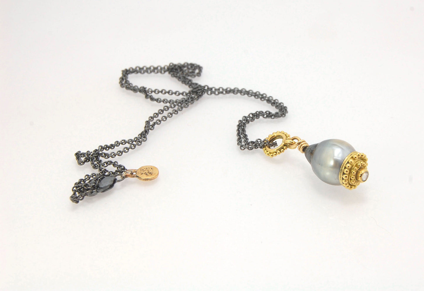 Baroque Grey Pearl with 18k gold Granulation and a Rosecut Diamond Ok this one is a stunner. 18k gold Granulated Dome with a 2.5 mm Rosecut Diamond and Granulated Bail pictured on an 18” peacock black oxidized Sterling Silver chain. Granulation is an anci