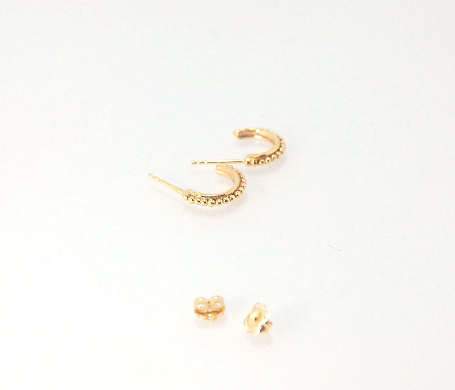 Etruscan Hoop Posts - Extra Small Huggies in 14k gold These are my smallest Etruscan Hoops as a post earring! Smaller than a dime - these post hoops hug your earlobe. So freakin’ cute! I like to wear them in my second piercing up and I prefer the gold! Bu