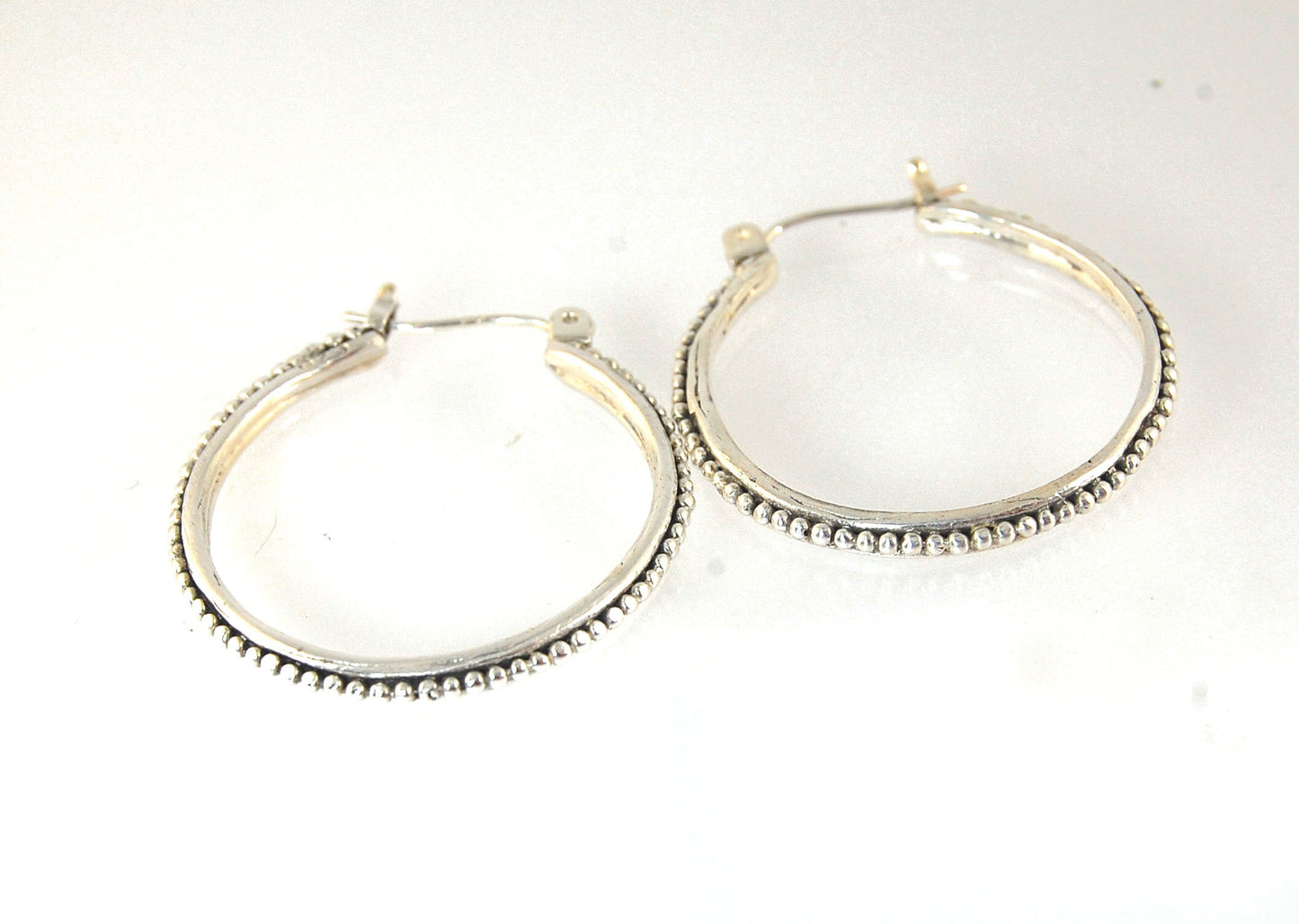 Etruscan Hoops in Sterling Silver - Large These sterling silver hoops are cast using the Lost Wax process from a granulated master for a limited edition series of hoops. I use fine silver for the original granulation, then make a mold, pull a wax copy fro