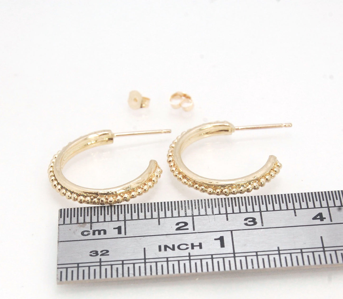Etruscan hoop posts in 14k Gold - Medium-SQ5258500 These 14k yellow gold hoops are cast in my studio from a granulated master for a limited edition series of hoops. I use fine silver for the original granulation, then make a mold, pull a wax copy from the