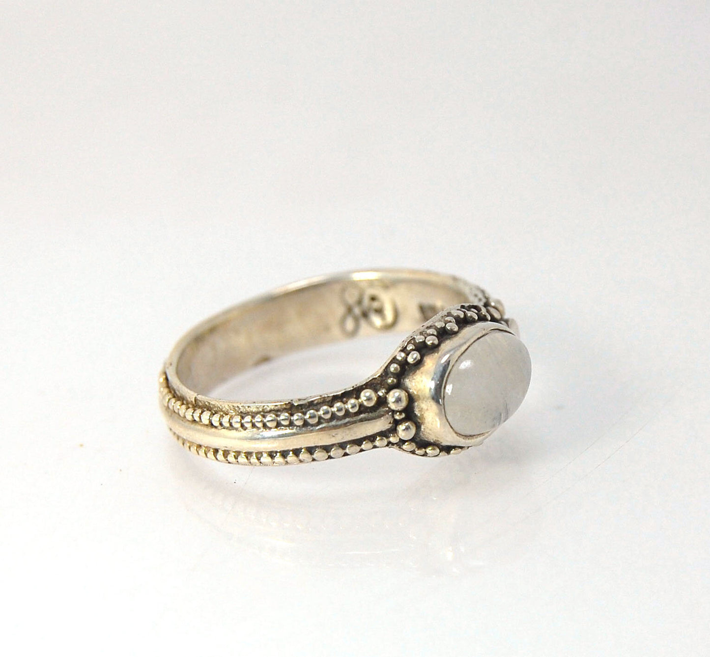 Rainbow Moonstone Fine Silver Asymmetrical Granulated Ring -size 8.5 This Moonstone cabochon is bezel-set in Fine Silver Granulation in a asymmetrical pattern.Granulation is an ancient fusing process utilized for thousands of years by the Etruscans and My