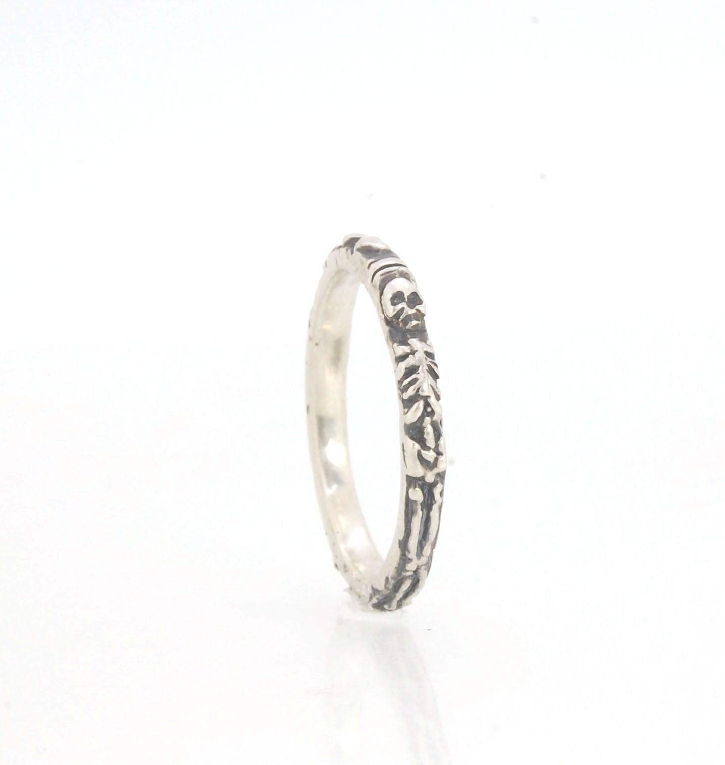Oxidized Memento Mori Skeleton Ring - 2.7mm - Sterling Silver This is the most narrow of my Memento Mori Skeleton rings at 2.7mm wide! The Skeleton is flanked by crossed bones on one side and intertwined hearts and an hourglass on the other. This is the 4