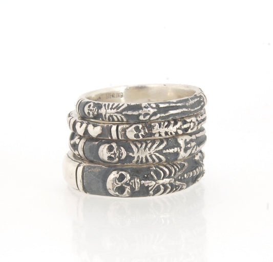 Oxidized Memento Mori Skeleton Ring - 4mm - Sterling Silver This is the middle width of my Memento Mori skeleton rings at 4mm wide. The Skeleton is flanked by crossed bones on one side and an hourglass on the other.Unlike my Enameled Memento Mori Rings, t