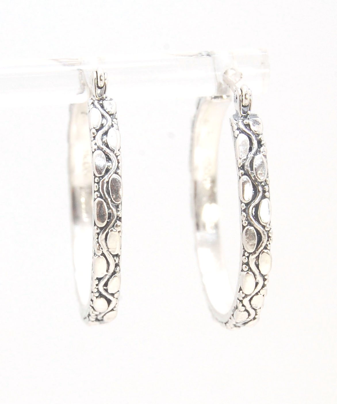 Ovals Pattern Hoops - Sterling in 3 sizes These Hoops are made from an Ovals pattern with heavy granules and ingot slices and have a hoop catch with a satisfying snap.These Ovals Hoops come in 3 sizes Large - 3mm wide and 1.25” in diameterMedium - 3mm wid