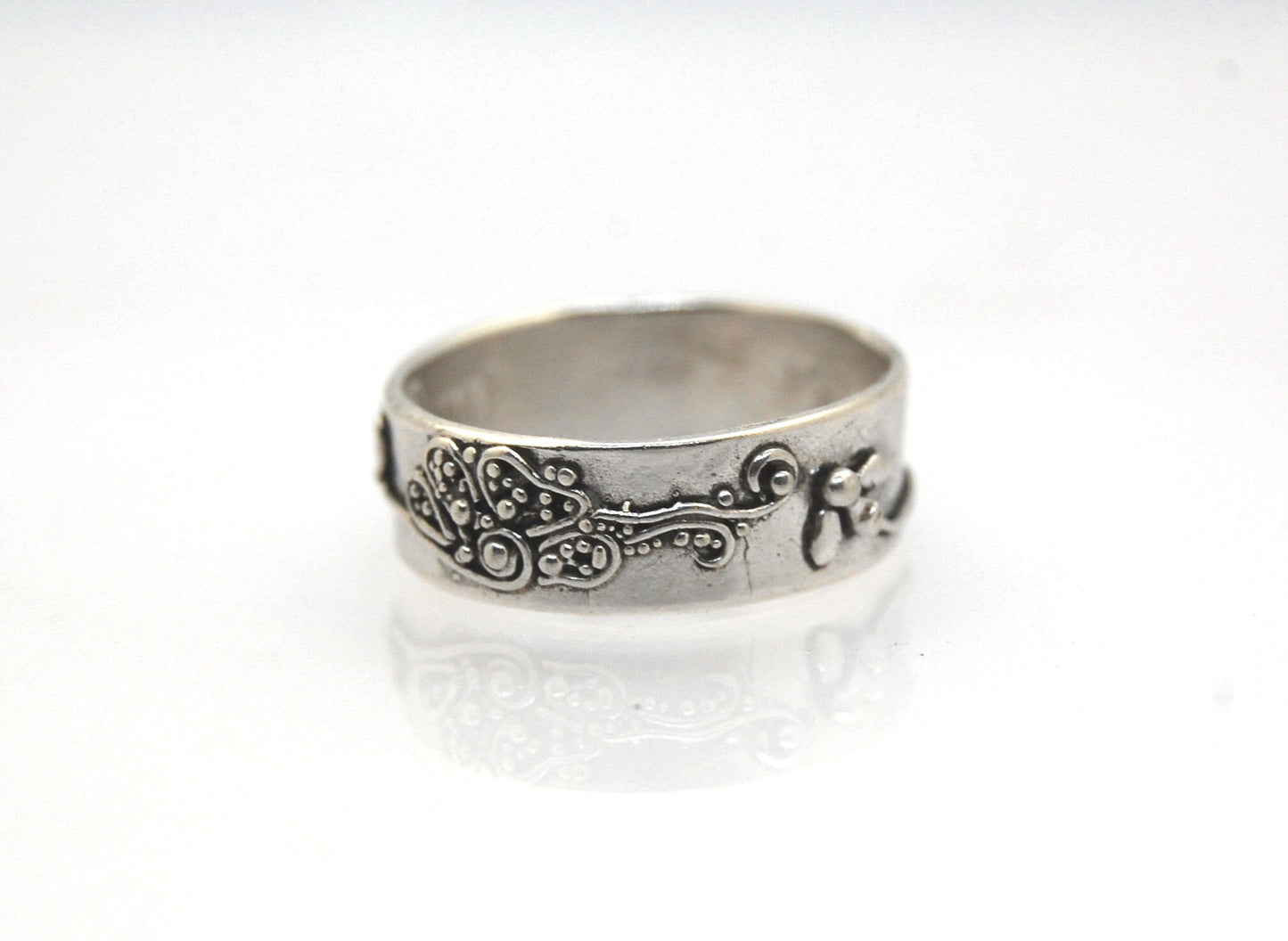 Pollinator Ring This Pollinator Band has a Bee and flower in tiny granulation. This band is a cast from a mold taken of a ring I granulated in fine silver. Granulation is an ancient fusing process that can only be done in certain highly pure metals that w