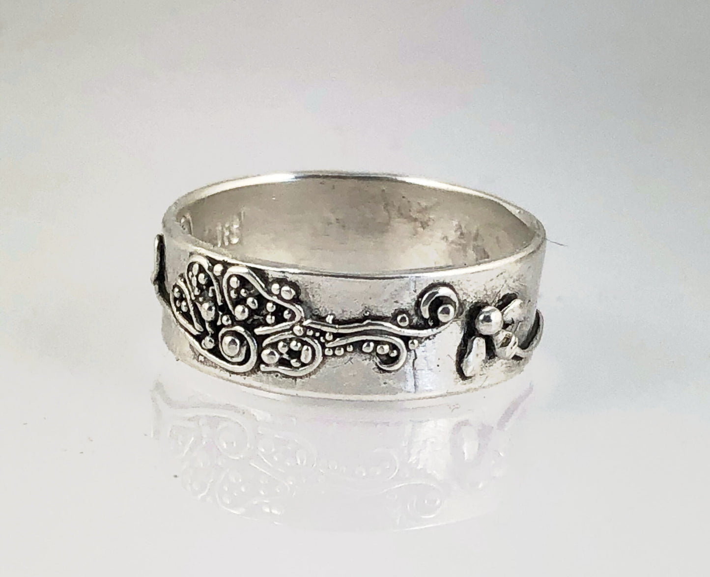 Pollinator Ring This Pollinator Band has a Bee and flower in tiny granulation. This band is a cast from a mold taken of a ring I granulated in fine silver. Granulation is an ancient fusing process that can only be done in certain highly pure metals that w