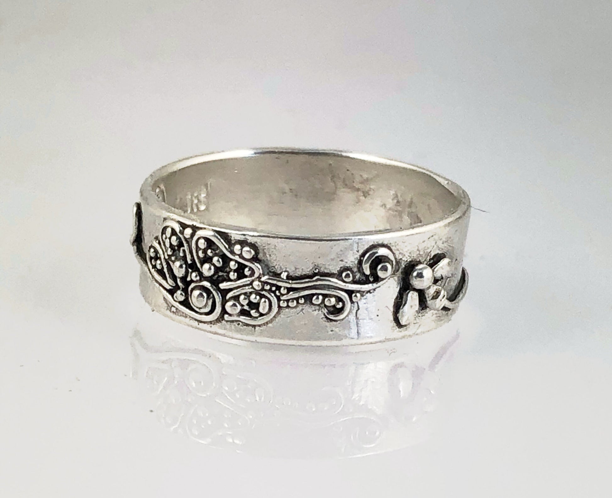 Pollinator Ring This Pollinator Band has a Bee and flower in tiny granulation. This band is a cast from a mold taken of a ring I granulated in fine silver. Granulation is an ancient fusing process that can only be done in certain highly pure metals that w