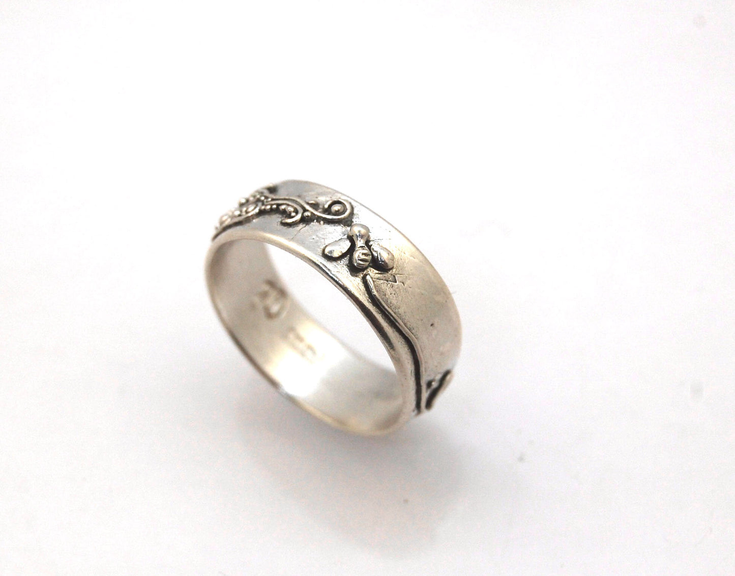 Pollinator Ring This Pollinator Band has a Bee and flower in tiny granulation. This band is a cast from a mold taken of a ring I granulated in fine silver. Granulation is an ancient fusing process that can only be done in certain highly pure metals that w