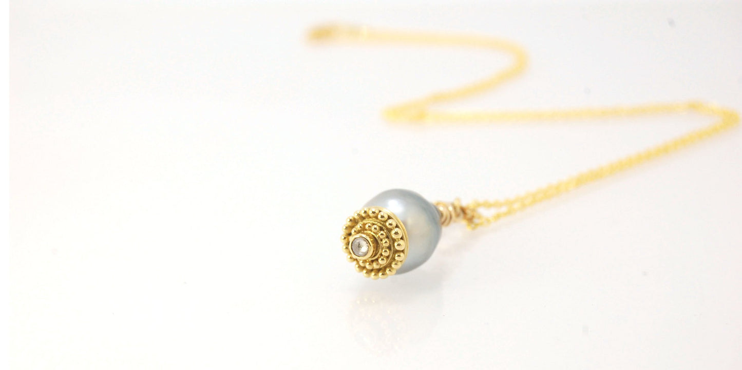 Baroque Grey Pearl with 18k gold Granulation and a Rosecut Diamond Ok this one is a stunner. 18k gold Granulated Dome with a 2.5 mm Rosecut Diamond and Granulated Bail pictured on an 18” peacock black oxidized Sterling Silver chain. Granulation is an anci