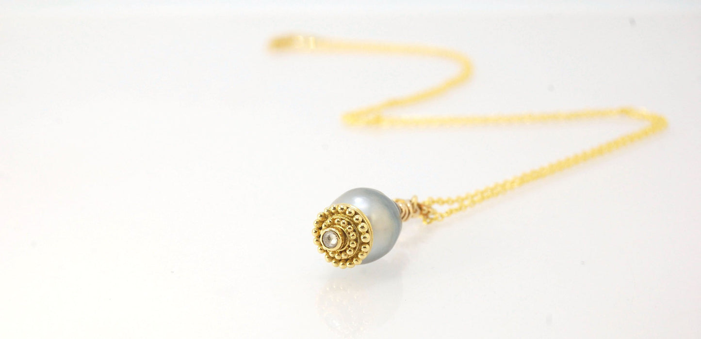 Baroque Grey Pearl with 18k gold Granulation and a Rosecut Diamond Ok this one is a stunner. 18k gold Granulated Dome with a 2.5 mm Rosecut Diamond and Granulated Bail pictured on an 18” peacock black oxidized Sterling Silver chain. Granulation is an anci
