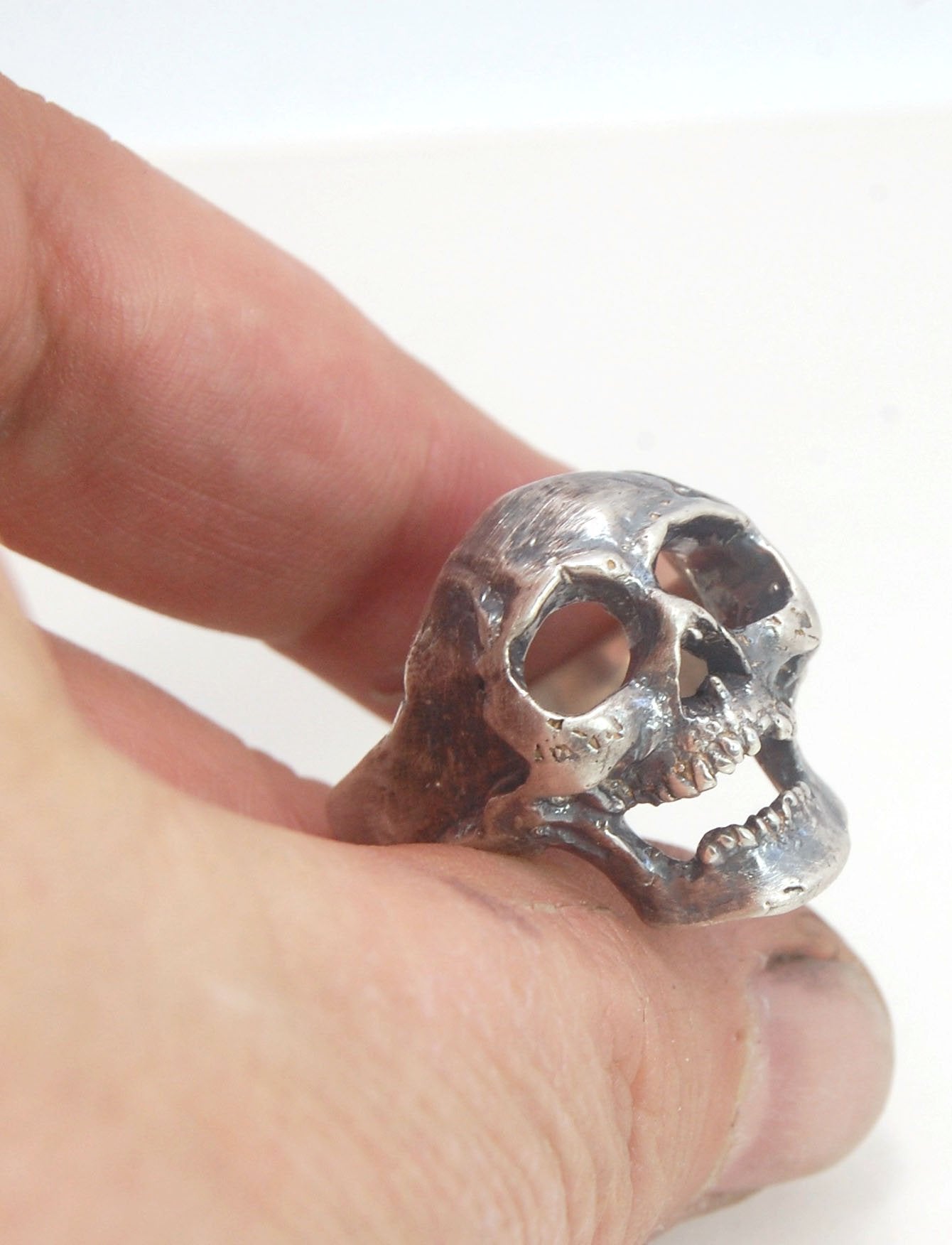 Screaming into the Void Skull Ring This is a lightweight but sizable skull ring that is Made to Order for you in your size. I carved this skull in wax, hollowed out the inside of the skull and cast it using the lost wax casting method. This Screaming into
