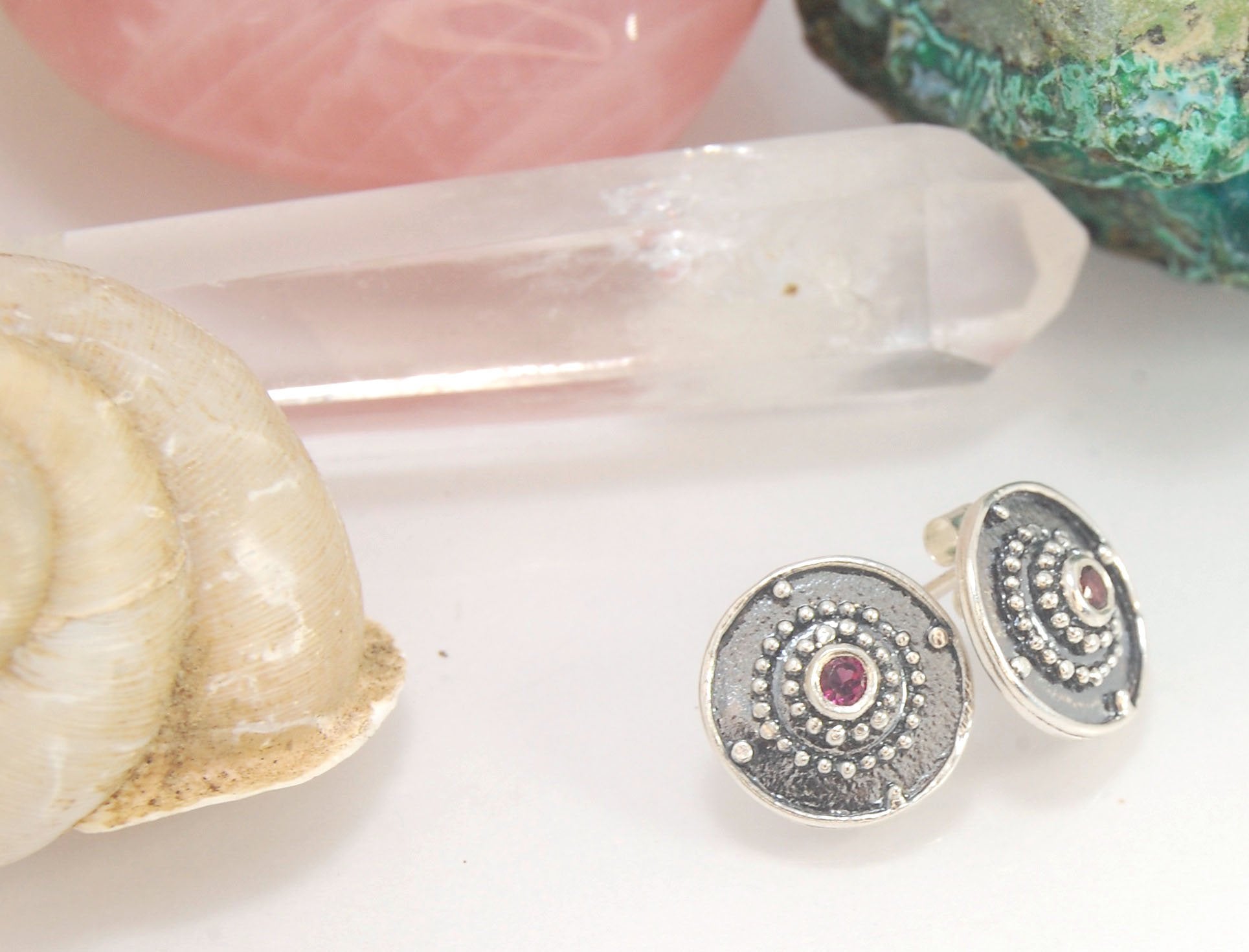 Post Shield Earrings in Sterling with Pink Garnet, Red Garnet, Blue Topaz, Peridot or Amethyst These terrific shield earrings are cast from a granulated original. and is cast using the lost wax process. You can choose which stone to set in your sterling s