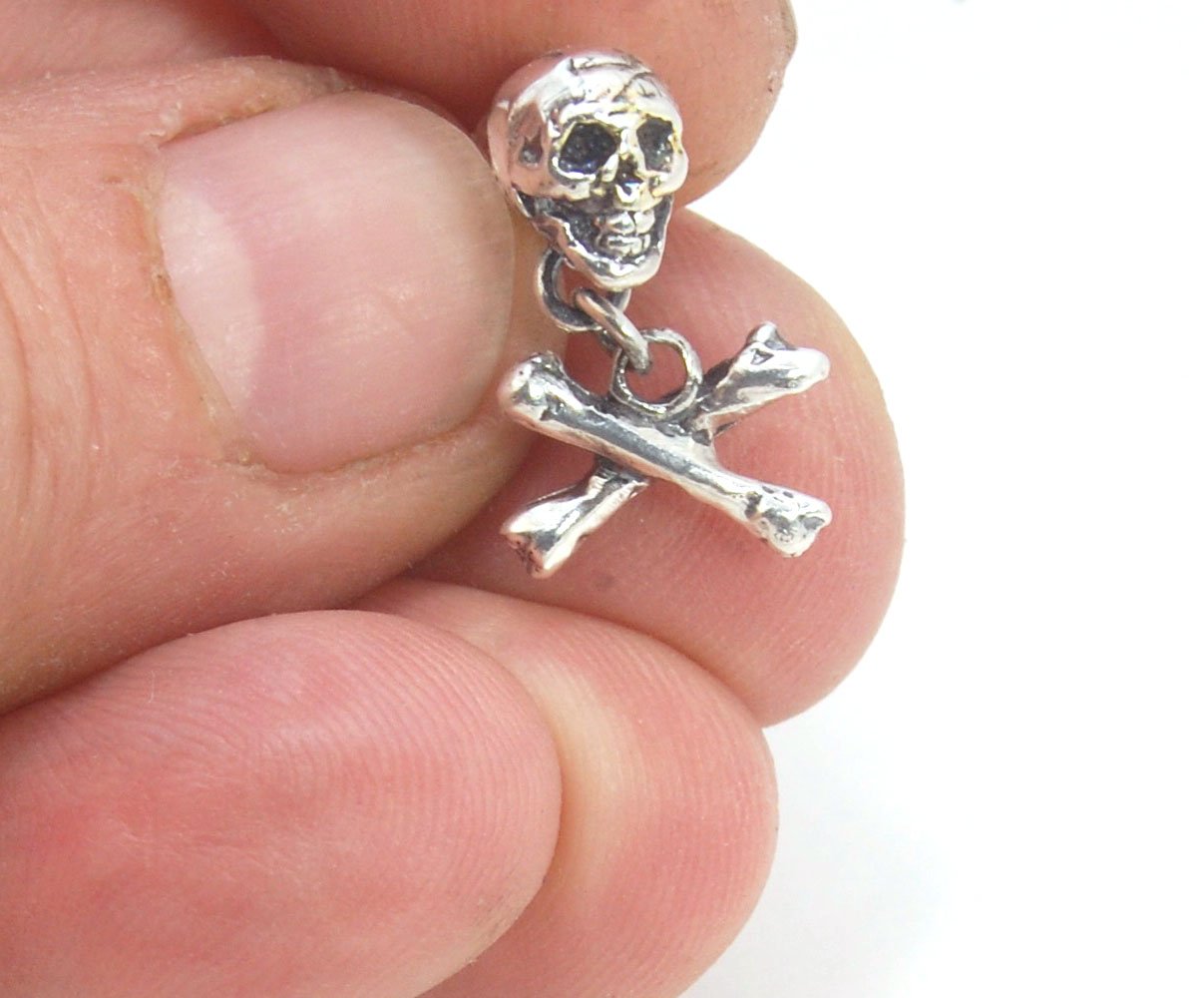 Skull & Bones Dangle Post Earrings These solid sterling silver Skull & Bones dangle earrings are wax carved by hand and cast using the ancient process of Lost Wax to cast them in sterling silver. I then made a mold, which I can inject with wax and make wa