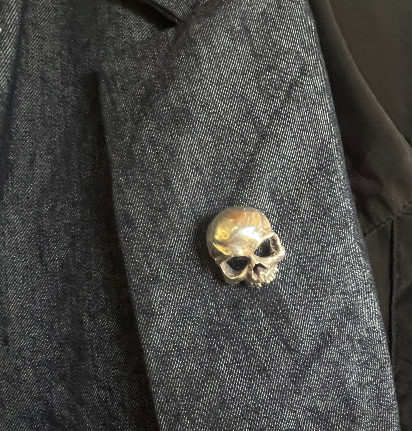 Through the Veil Darkly Skull Face Pin This Through the Veil Darkly Skull Face pin in Sterling Silver has a lot of expression and a nice weight with a hinged pin stem and clasp. It’s not too big or too small or too heavy. It will look great on your sweate