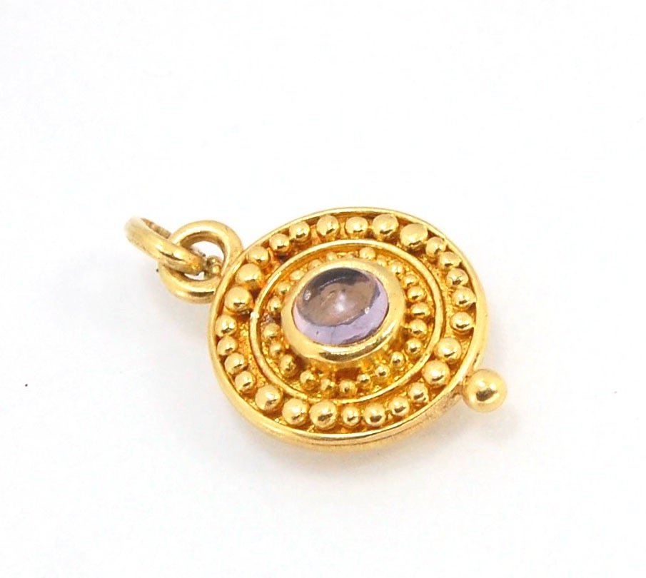 Amethyst 18k Gold Granulation Medallion This lovely light amethyst cabochon is surrounded by the 18k gold bezel setting and 18k gold granulation with a notched granulated bail. This classically inspired medallion looks like it could have come from buried