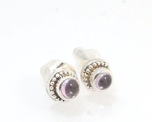 Amethyst Tiny Post Earrings in Sterling Silver These are tiny bezel settings I created using the ancient process of granulation. I then made a mold of it and injected the mold with wax and used that wax to create a Sterling Silver version of these granula