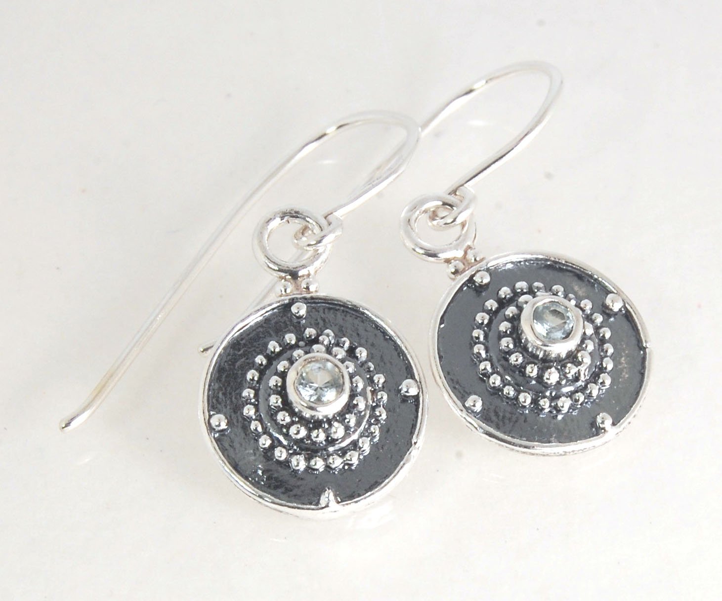 Dangle Shield Earrings in Sterling with Pink Garnet, Red Garnet, Blue Topaz, Peridot, or Amethyst These terrific shield earrings are cast from a granulated original. and is cast using the lost wax process. You can choose which stone to set in your sterlin