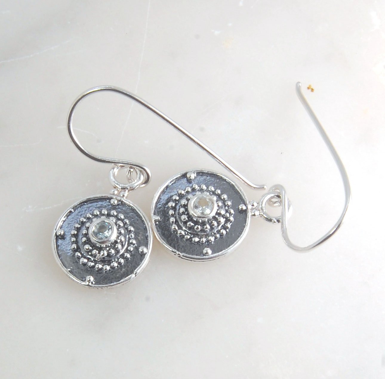 Dangle Shield Earrings in Sterling with Pink Garnet, Red Garnet, Blue Topaz, Peridot, or Amethyst These terrific shield earrings are cast from a granulated original. and is cast using the lost wax process. You can choose which stone to set in your sterlin