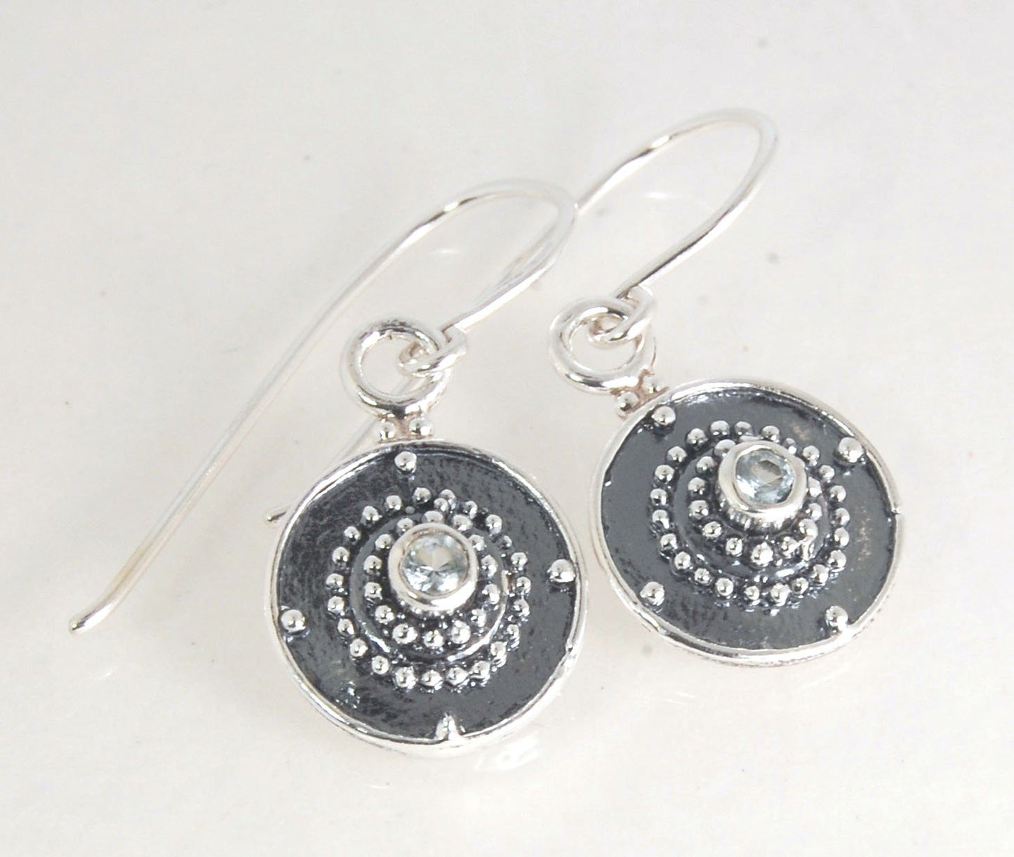 Dangle Shield Earrings in Sterling with Pink Garnet, Red Garnet, Blue Topaz, Peridot, or Amethyst These terrific shield earrings are cast from a granulated original. and is cast using the lost wax process. You can choose which stone to set in your sterlin