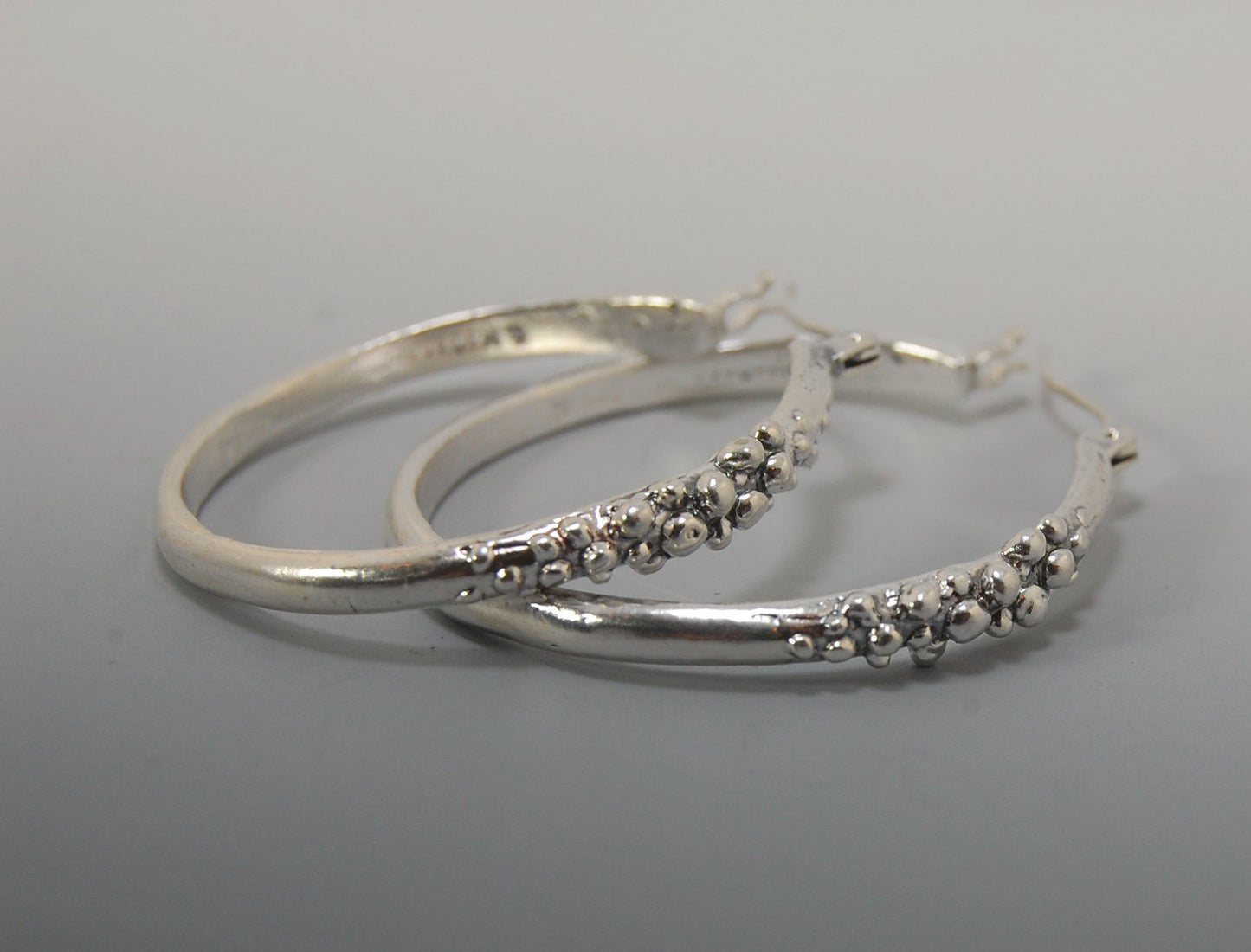 Bubble Hoops in Sterling These are great, unusual sterling silver bubble hoops. Carved in Wax and Cast in sterling silver with a lost wax process in my studio, these bubble beauties have a nice weight and the ear wire and clasp have a satisfying click. Da