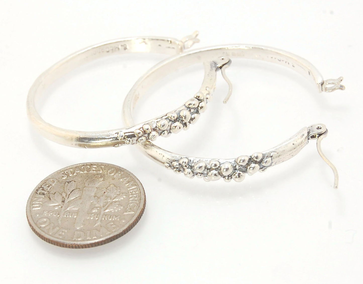 Bubble Hoops in Sterling These are great, unusual sterling silver bubble hoops. Carved in Wax and Cast in sterling silver with a lost wax process in my studio, these bubble beauties have a nice weight and the ear wire and clasp have a satisfying click. Da