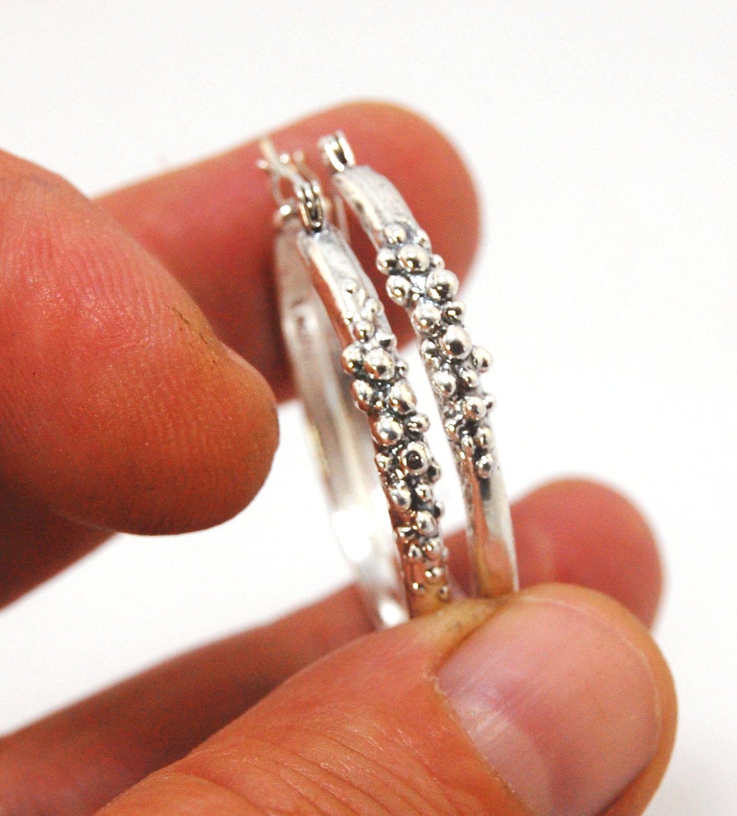 Bubble Hoops in Sterling These are great, unusual sterling silver bubble hoops. Carved in Wax and Cast in sterling silver with a lost wax process in my studio, these bubble beauties have a nice weight and the ear wire and clasp have a satisfying click. Da