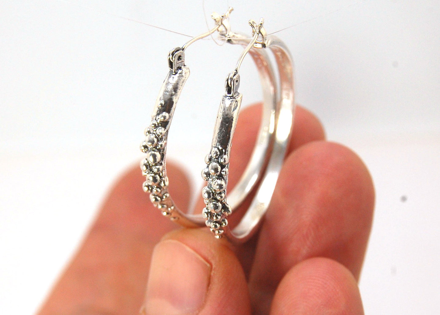 Bubble Hoops in Sterling These are great, unusual sterling silver bubble hoops. Carved in Wax and Cast in sterling silver with a lost wax process in my studio, these bubble beauties have a nice weight and the ear wire and clasp have a satisfying click. Da