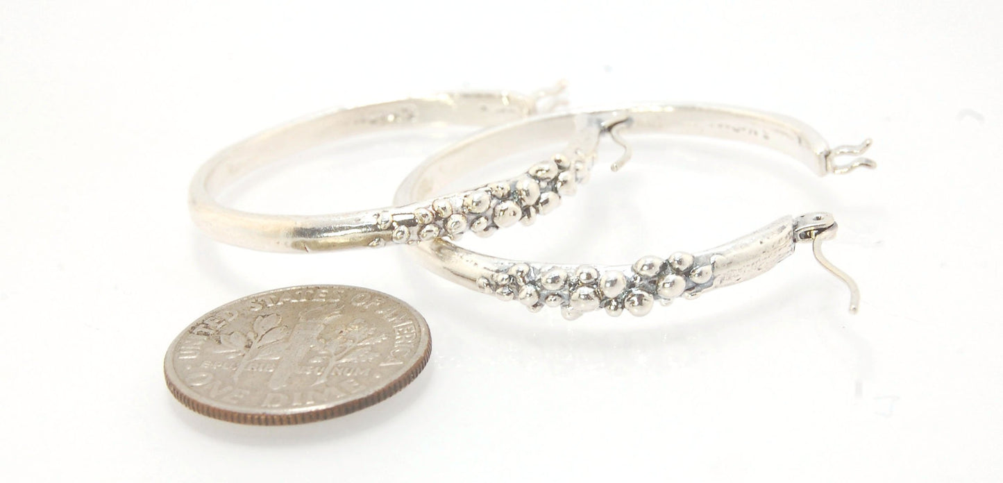 Bubble Hoops in Sterling These are great, unusual sterling silver bubble hoops. Carved in Wax and Cast in sterling silver with a lost wax process in my studio, these bubble beauties have a nice weight and the ear wire and clasp have a satisfying click. Da