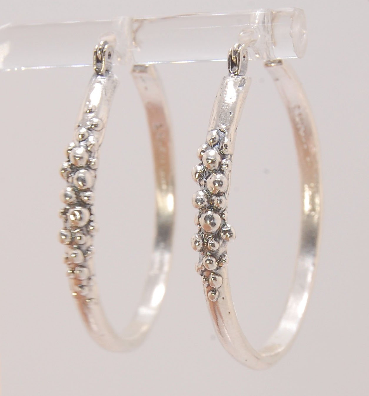Bubble Hoops in Sterling These are great, unusual sterling silver bubble hoops. Carved in Wax and Cast in sterling silver with a lost wax process in my studio, these bubble beauties have a nice weight and the ear wire and clasp have a satisfying click. Da
