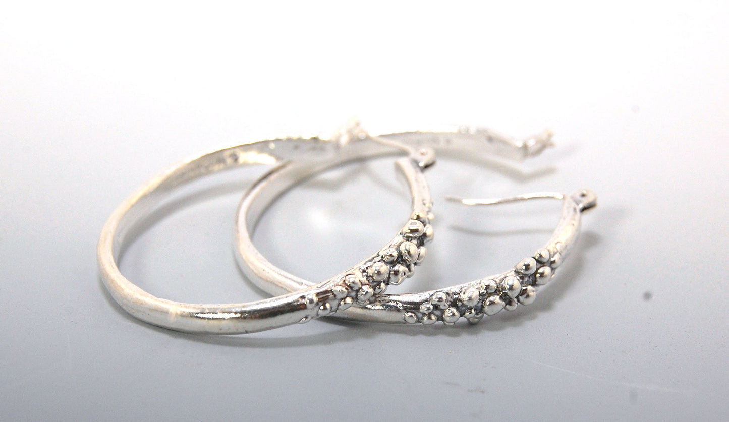 Bubble Hoops in Sterling These are great, unusual sterling silver bubble hoops. Carved in Wax and Cast in sterling silver with a lost wax process in my studio, these bubble beauties have a nice weight and the ear wire and clasp have a satisfying click. Da