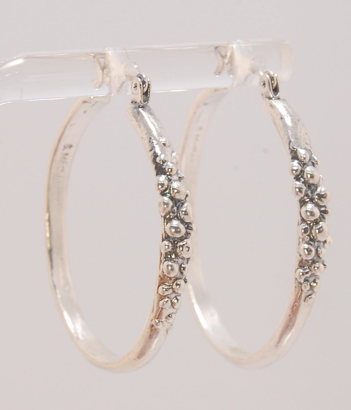 Bubble Hoops in Sterling These are great, unusual sterling silver bubble hoops. Carved in Wax and Cast in sterling silver with a lost wax process in my studio, these bubble beauties have a nice weight and the ear wire and clasp have a satisfying click. Da