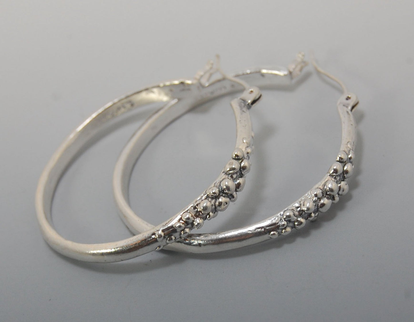 Bubble Hoops in Sterling These are great, unusual sterling silver bubble hoops. Carved in Wax and Cast in sterling silver with a lost wax process in my studio, these bubble beauties have a nice weight and the ear wire and clasp have a satisfying click. Da